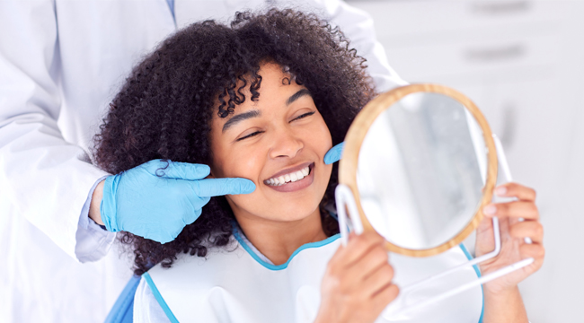Adult dental care patient smiling during treatment in Austin TX