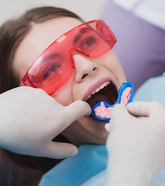 Patient receiving fluoride treatment at Hapii Dental in Austin, TX.