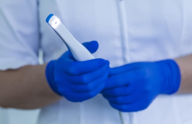 Dentist using an intraoral camera during a dental exam at Hapi Dental in Austin TX