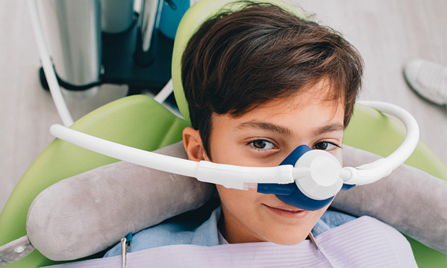 Child receiving laughing gas sedation during a comfortable dental treatment in Austin, TX